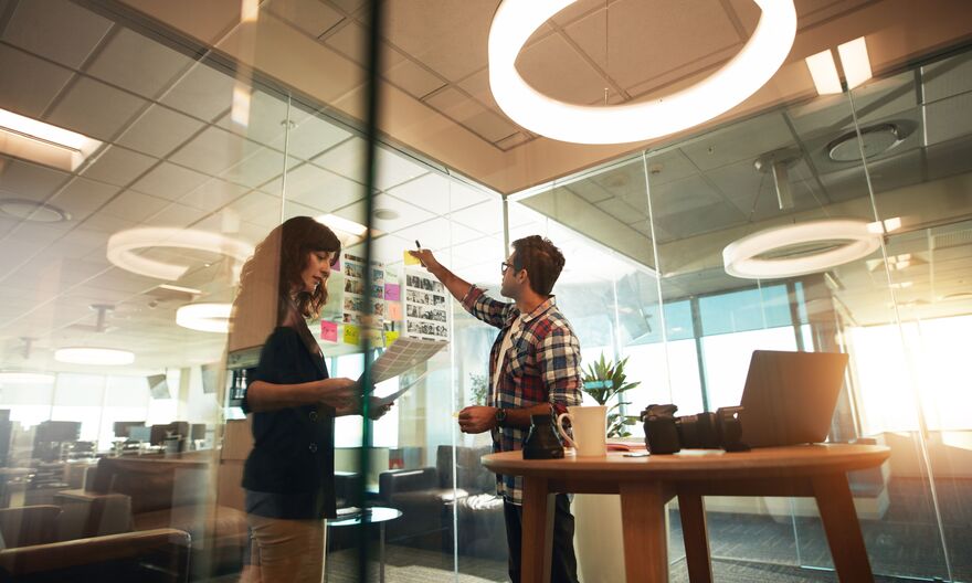 Woman and man in office doing creative work