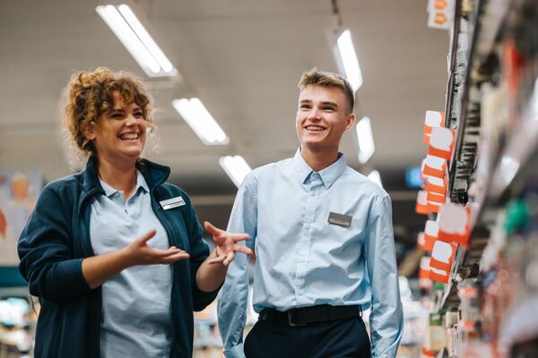 Local grocery store manager training new male employee
