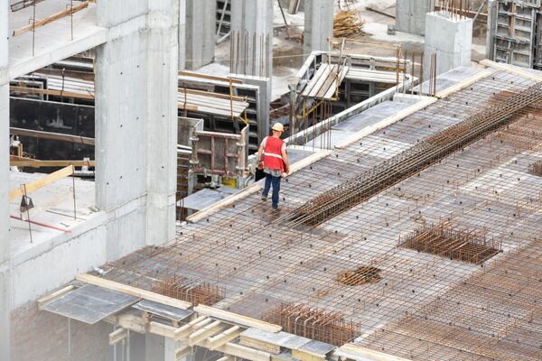 construction site workers working with cranes and excavators