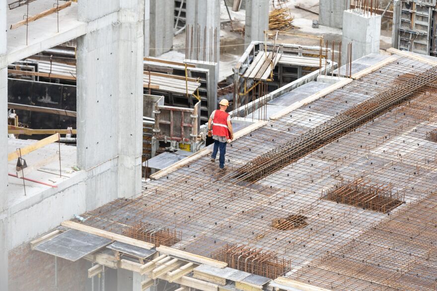 construction site workers working with cranes and excavators