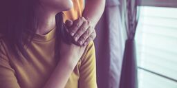 woman with comforting hand on shoulder