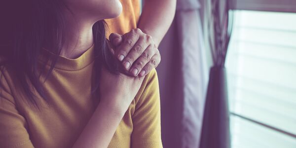 woman with comforting hand on shoulder
