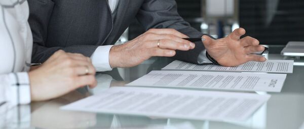 hands of business people gesturing over paperwork