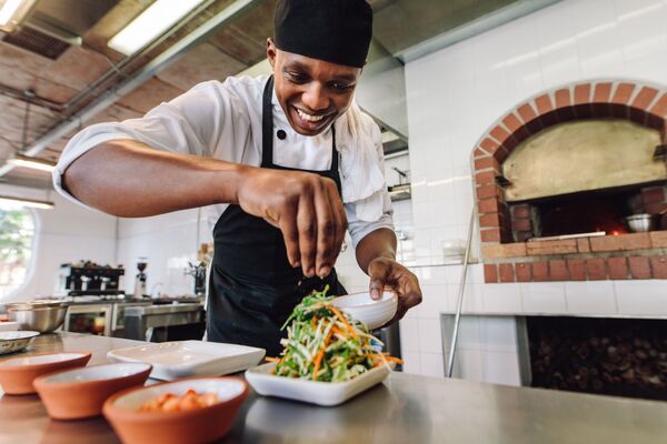 Male chef preparing salad