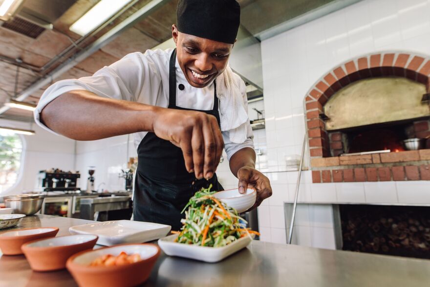 Male chef preparing salad