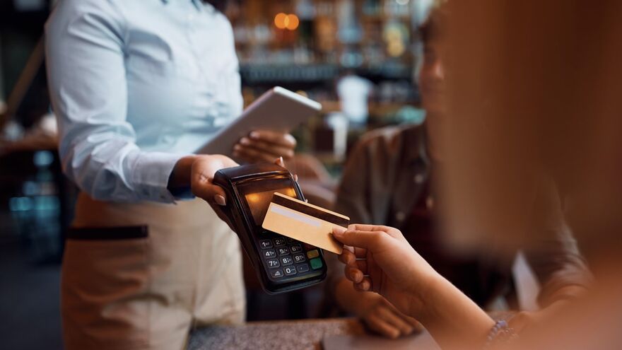 Hospitality Worker taking payment 