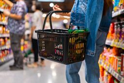 Woman holding supermarket basket