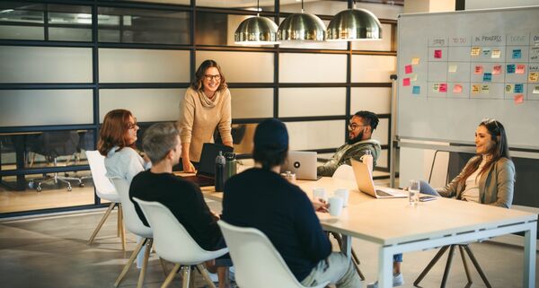 People gathered round a board room table 
