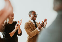 Man applauding with colleages