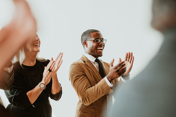 Man applauding with colleages