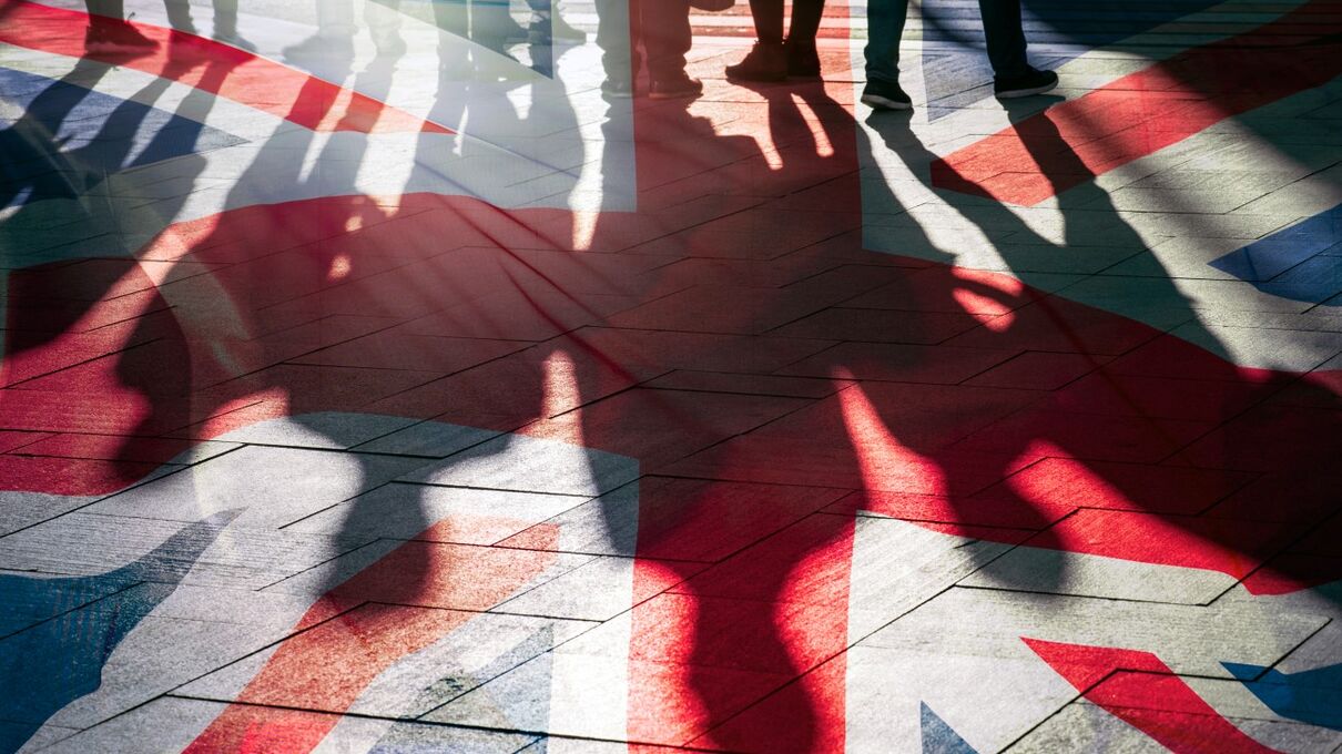 people walking on UK flag painted on the floor