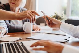 older couple signing paperwork