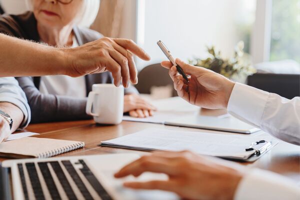 older couple signing paperwork