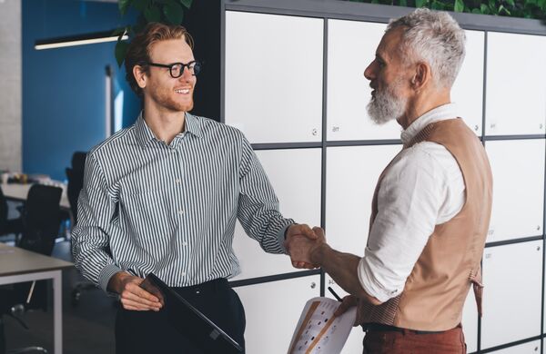 Two men shaking hands on deal