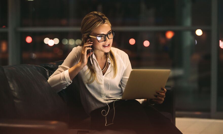 Women looking at tablet while speaking through earphones