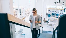 Woman in office looking at phone