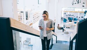 Woman in office looking at phone