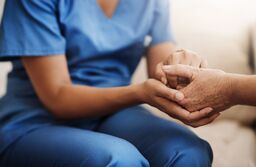 Caregiver, support and senior woman holding hands