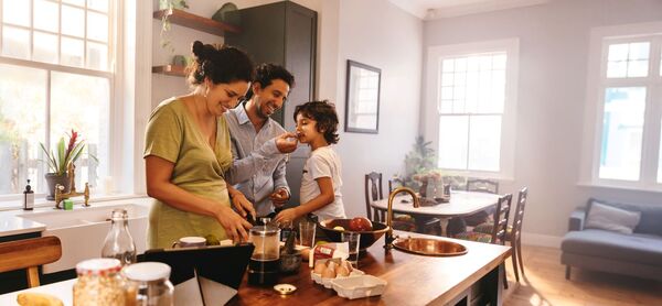 young family cooking in kitchen