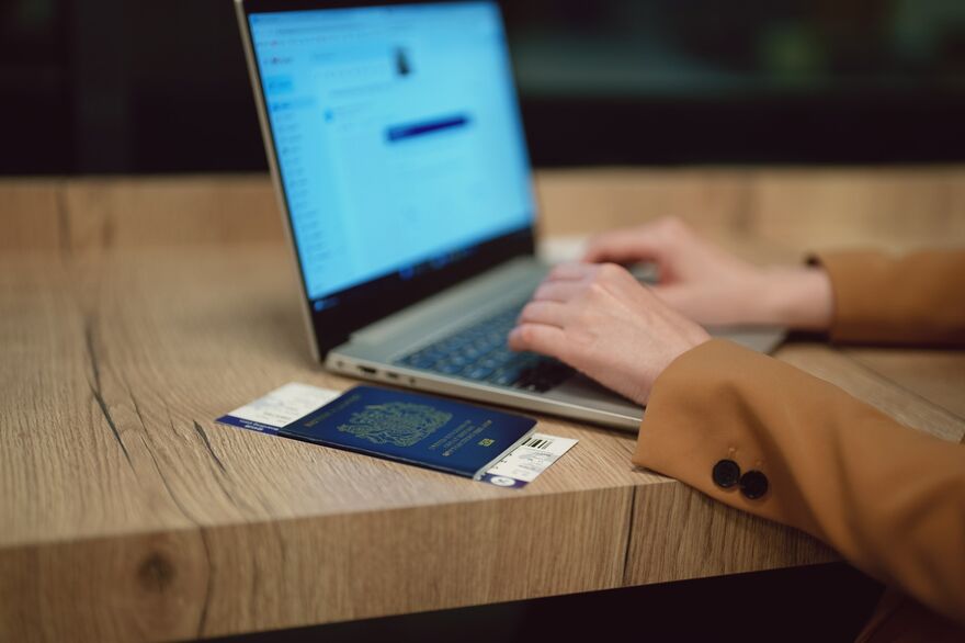 British passport and person on laptop