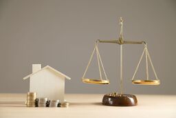 House/ money and weighing scales