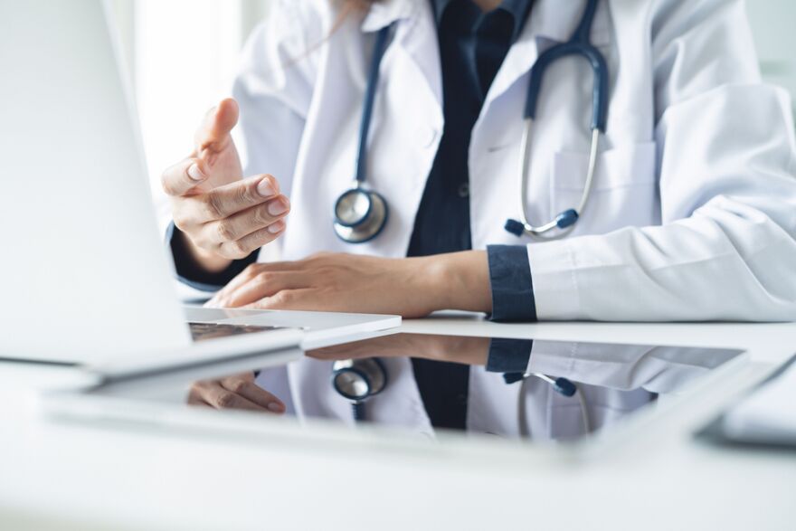 Telemedicine concept. Female doctor giving online consultation to patient via laptop computer at clinic office  for domestic health treatment. remote medical appointment, telehealth